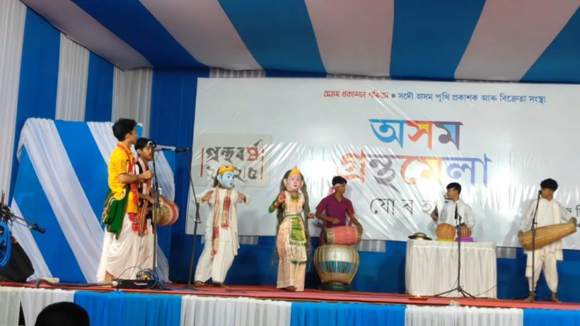 Masked performers with musicians on stage