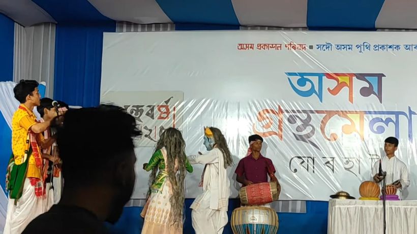 Students in Bihu dress performing with instruments