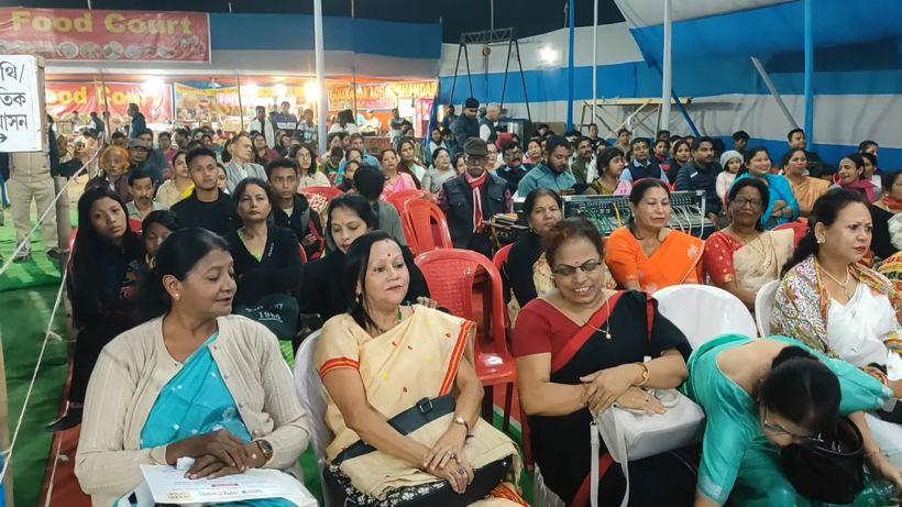 Women in the front rows of the audience, smiling