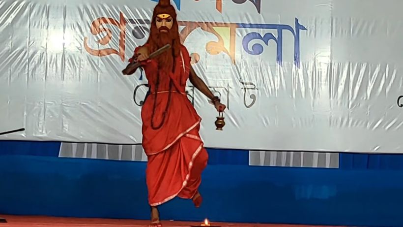 A performer in a red costume in a dramatic pose