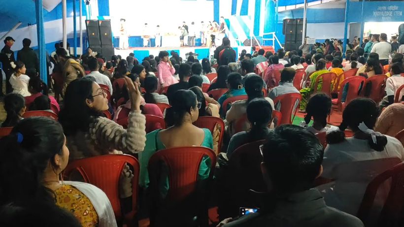 A large audience seated in the book fair pavilion