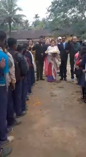 Students lined up on the school path to welcome guests
