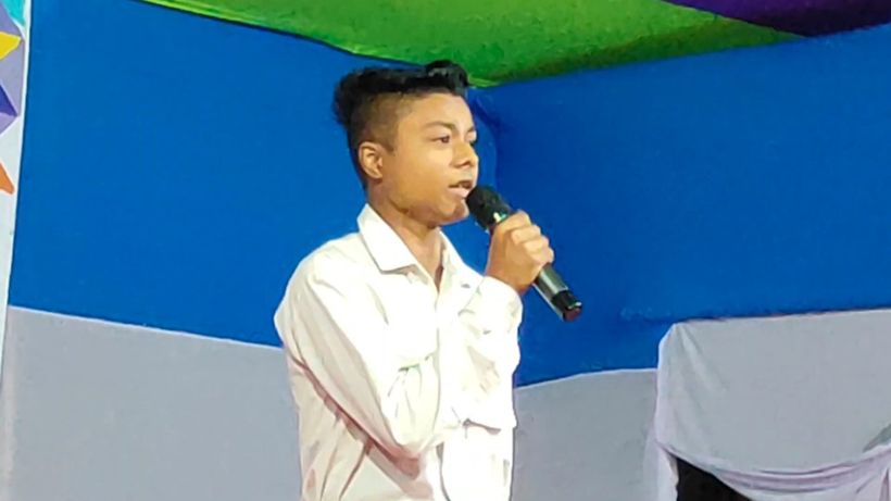 A boy singing into a microphone